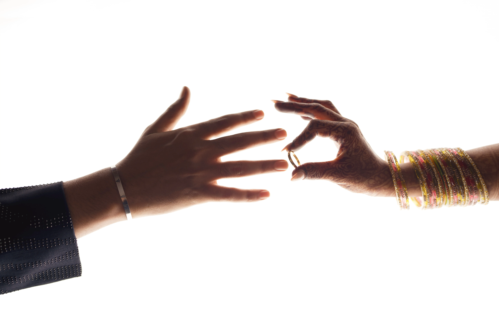 Hands exchanging a wedding ring